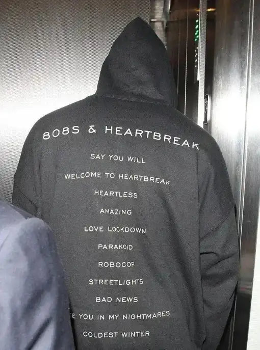 back view of the black 808s & Heartbreak pullover hoodie featuring the full album tracklist.