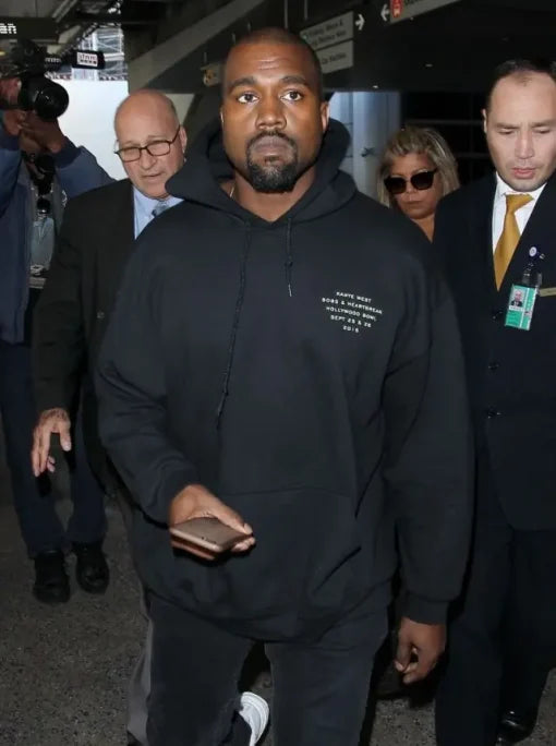 Kanye West wearing an oversized black pullover hoodie
