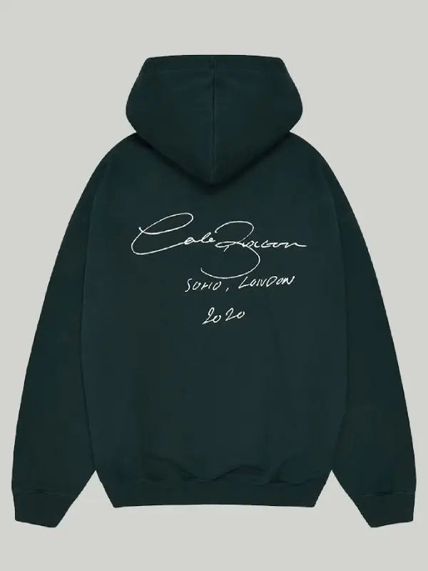 Back view of green hoodie, featuring 'SOHO, LONDON 2020' text.
