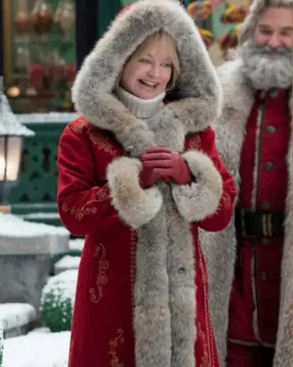 Mrs. Claus (Goldie Hawn) wearing a red coat with a large fur-trimmed hood