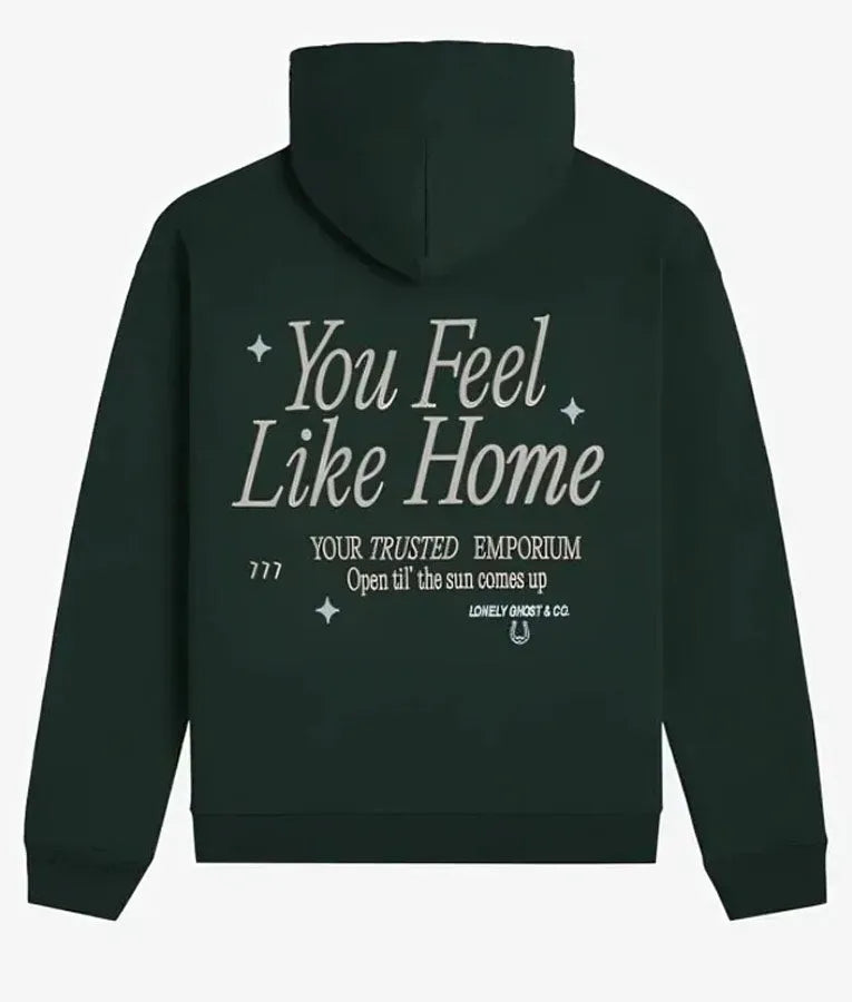 Back view of green pullover hoodie with text 'You Feel Like Home'