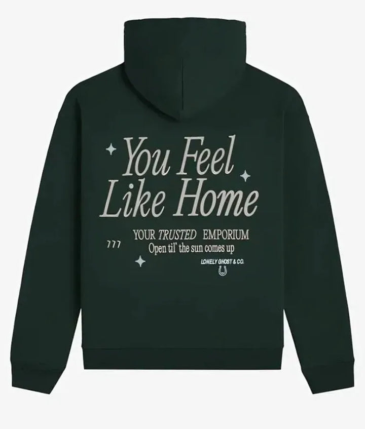 Back view of green pullover hoodie with text 'You Feel Like Home'
