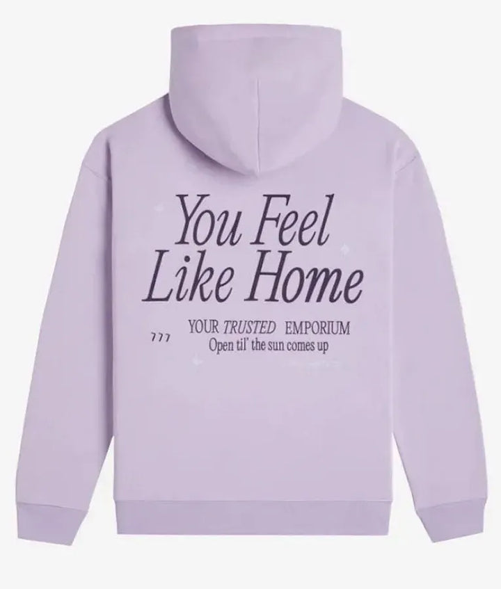 Back view of a light pullover hoodie text 'You Feel Like Home'