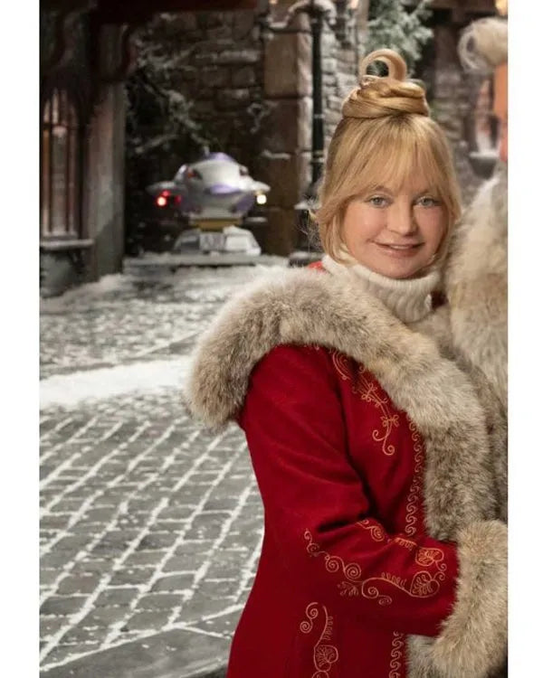 Close-up of Goldie Hawn in a red Mrs. Claus coat with fur trim