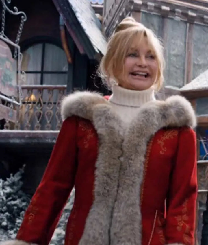 Close-up portrait of Goldie Hawn as Mrs. Claus in a red coat with light fur trim