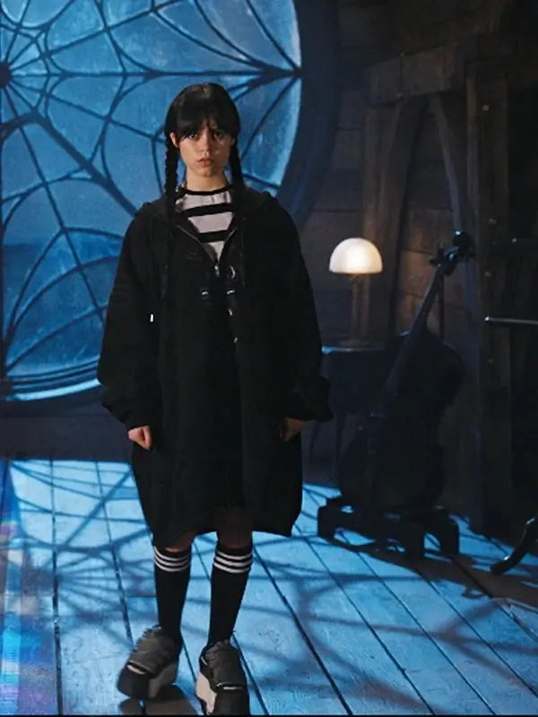 front view of Jenna Ortega as Wednesday, wearing the oversized, long black zippered hoodie