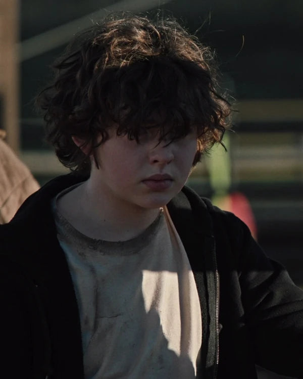 Close-up view of the Tate Dutton from Yellowstone, wearing black zip-up hoodie